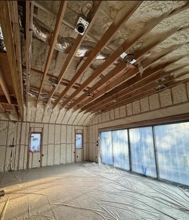 Interior walls and ceiling insulated with spray foam during new construction in Barnstable Town